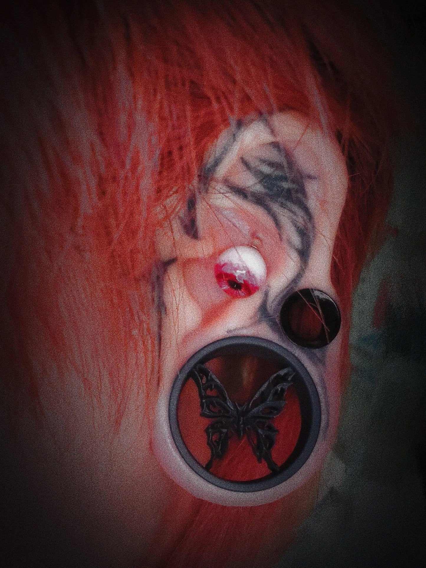 Side profile of a model wearing Butterfly double flared ear tunnels with multiple piercings