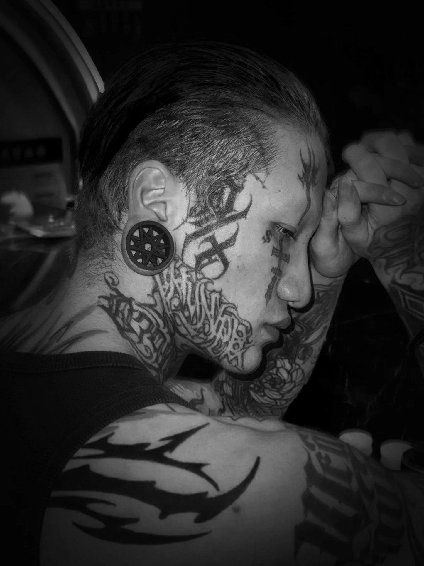 Black and white side profile of a model wearing a Decagram double flared ear tunnel