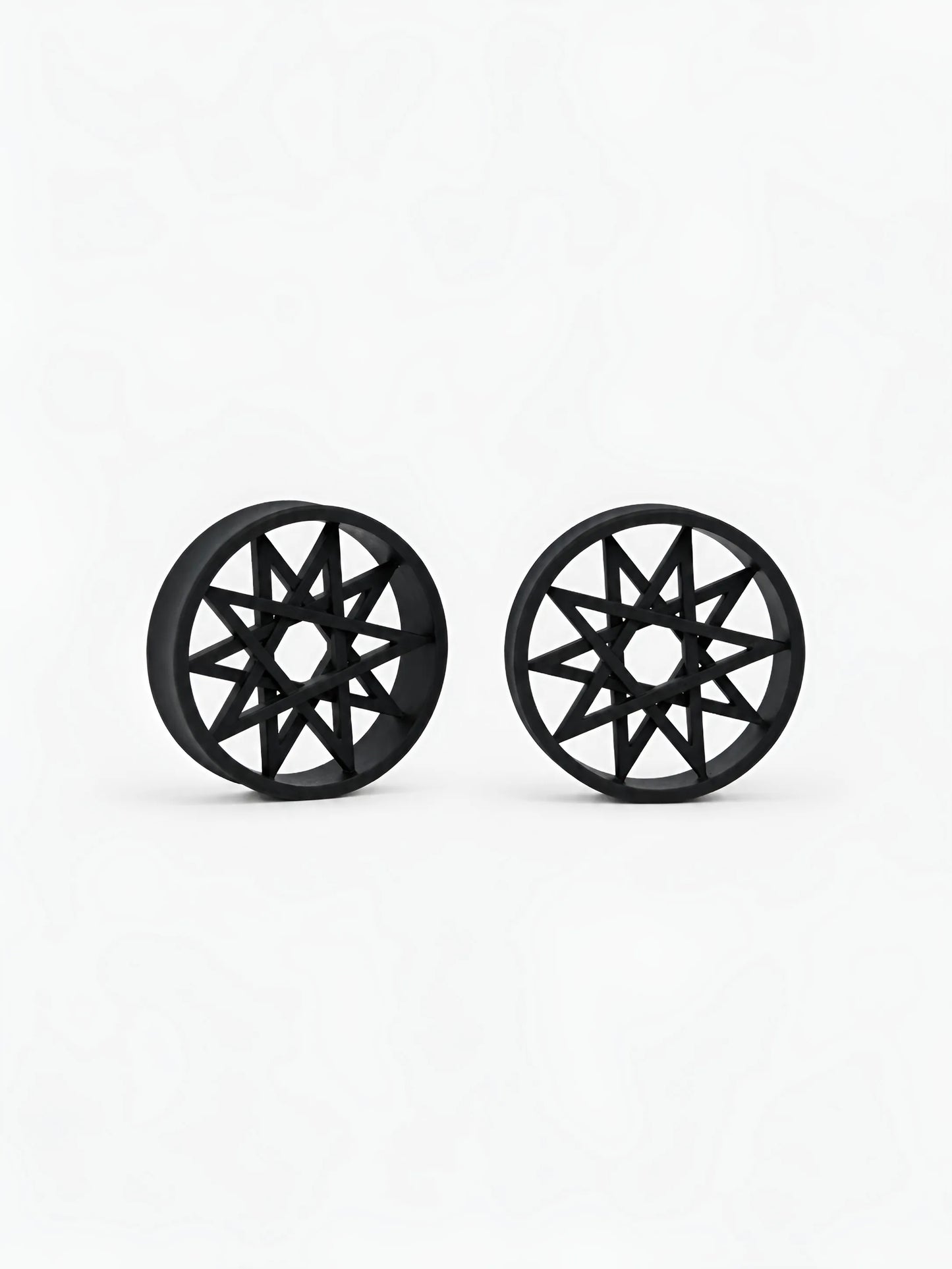 Pair of black Decagram double flared ear tunnels on a white background