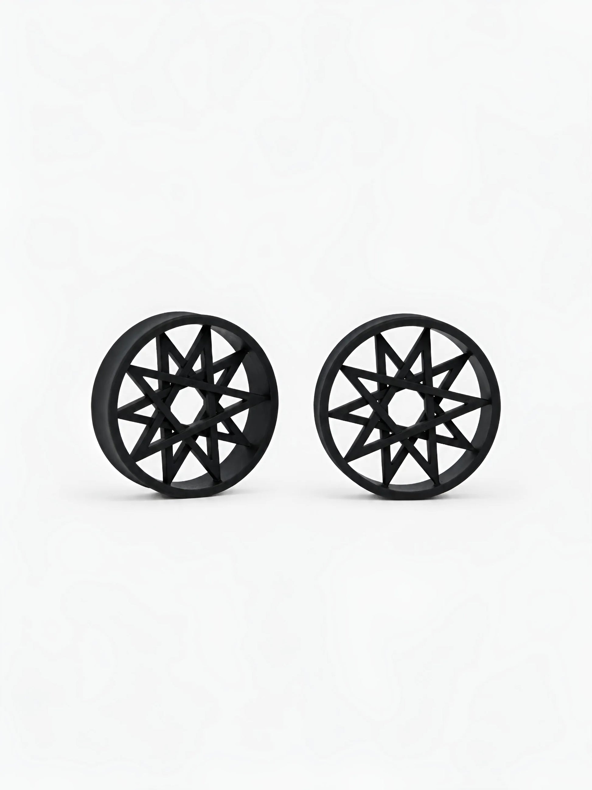 Pair of black Decagram double flared ear tunnels on a white background