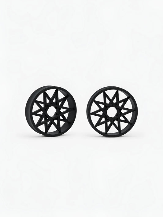 Pair of black Decagram double flared ear tunnels on a white background