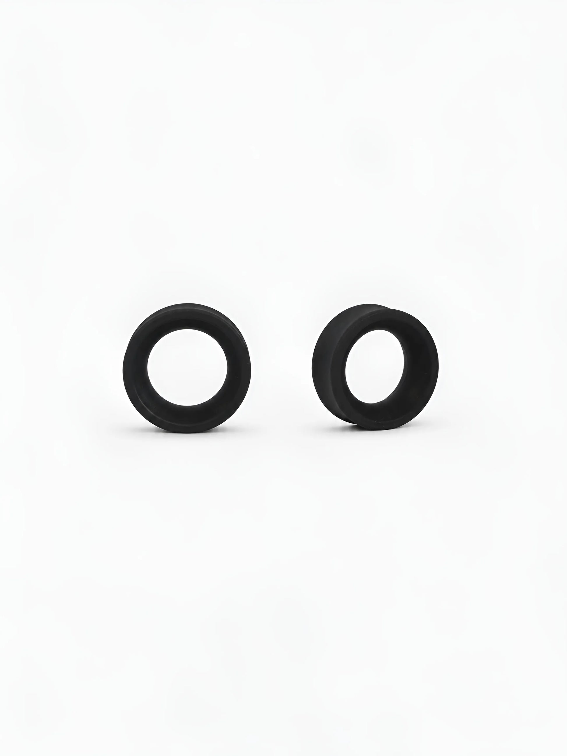 Pair of black Ring double flared ear tunnels on a white background
