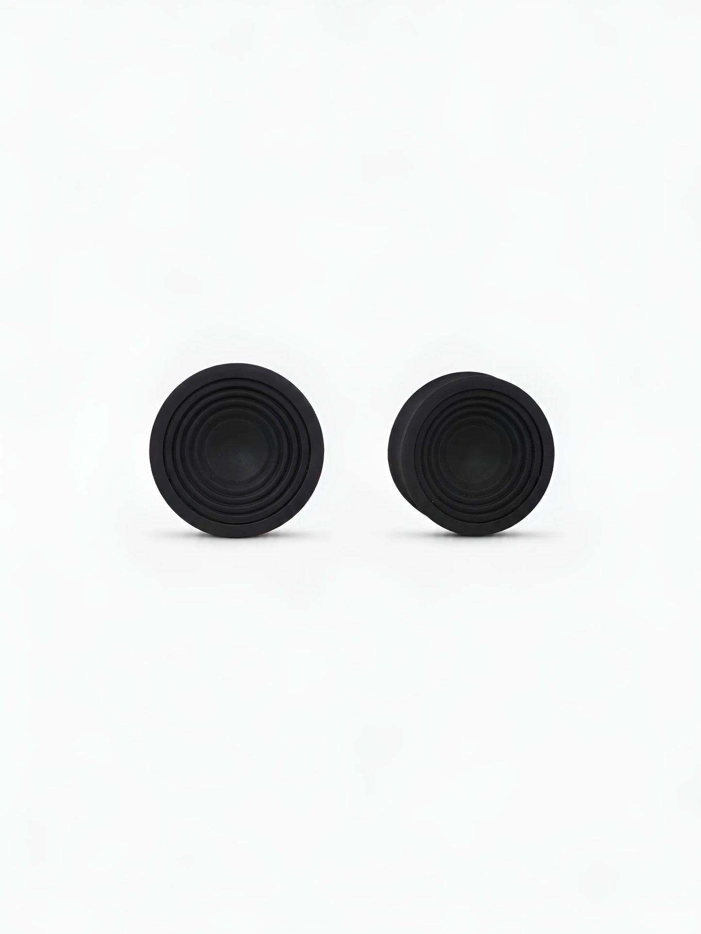 Pair of translucent Ripple double flared ear plugs on a white background