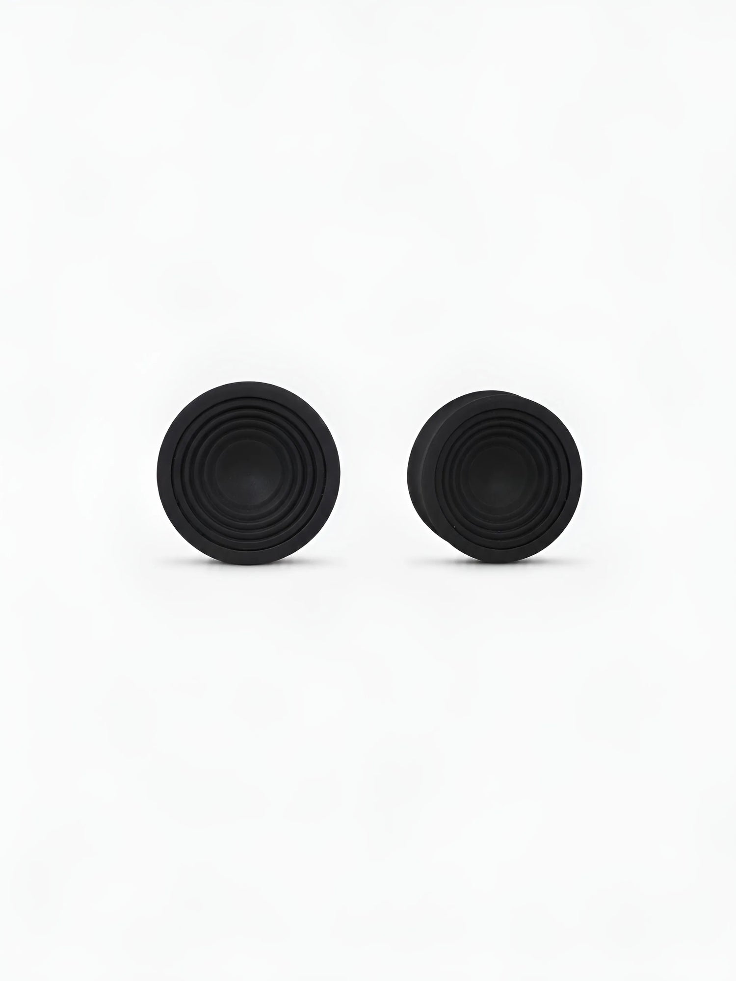 Pair of translucent Ripple double flared ear plugs on a white background