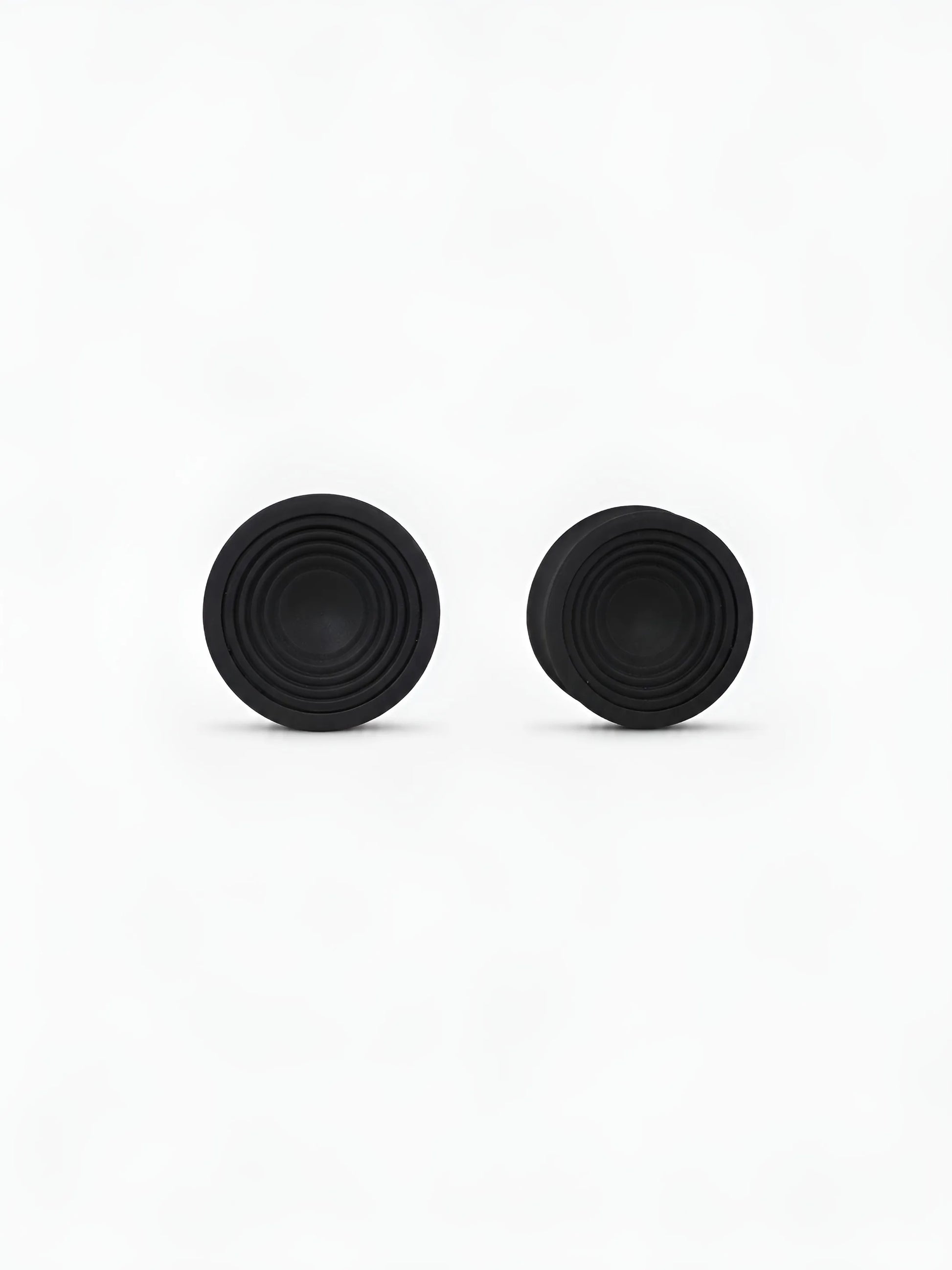 Pair of translucent Ripple double flared ear plugs on a white background