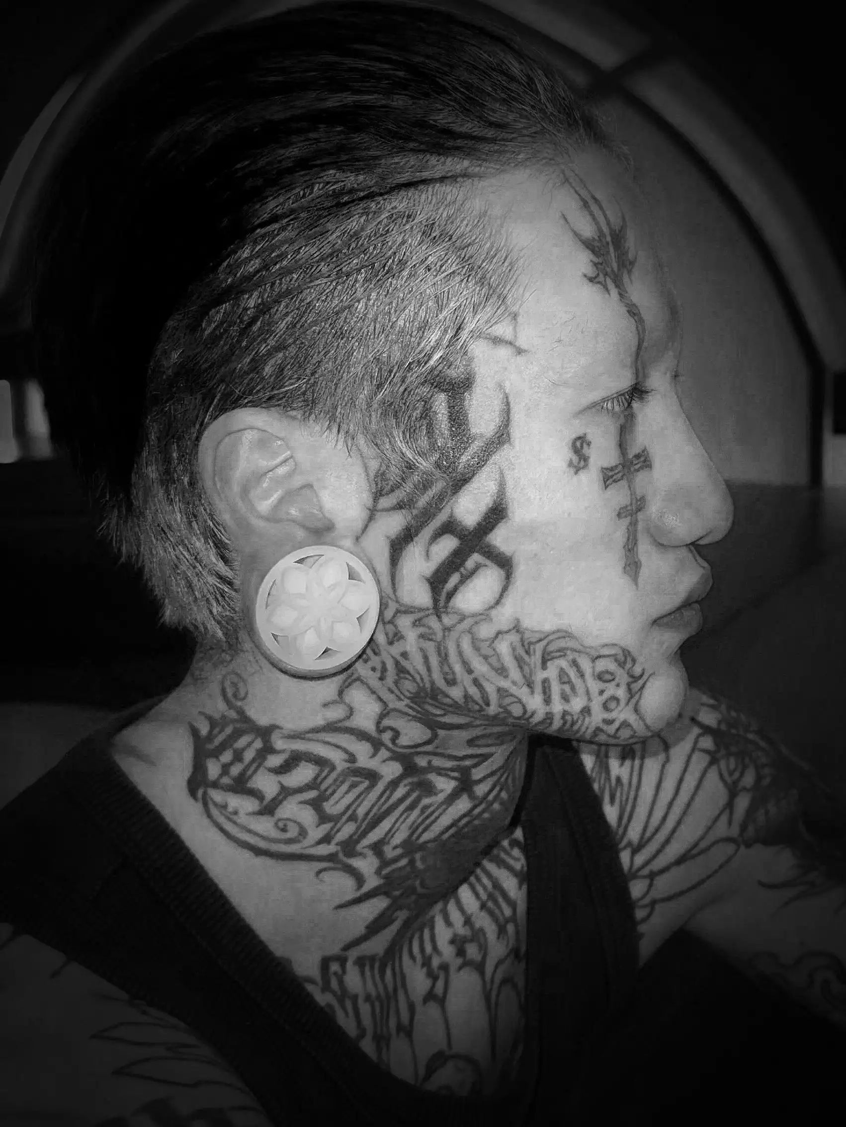 Lotus double flared ear tunnels worn in side profile