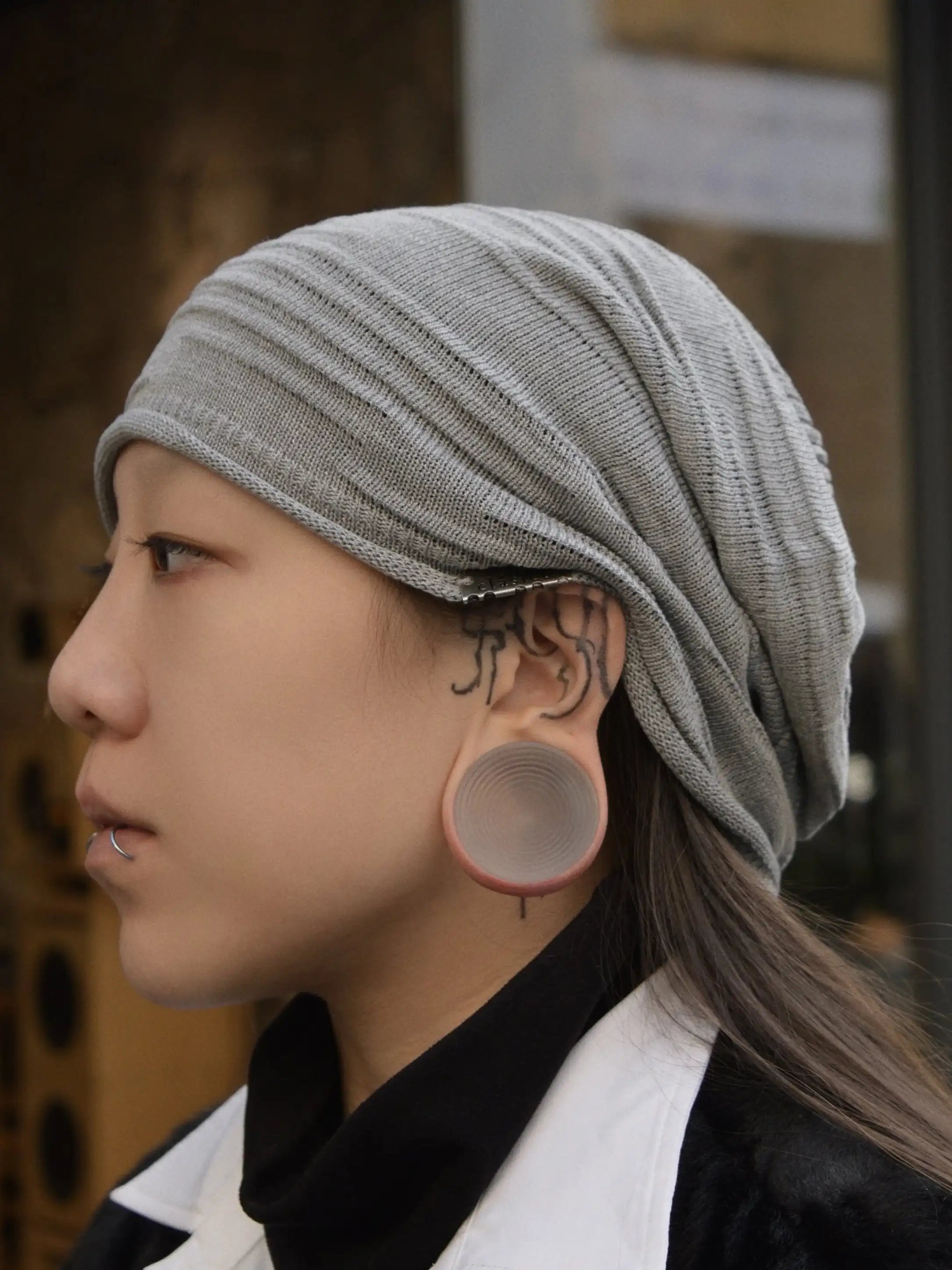 Ripple double flared ear tunnels worn in side profile