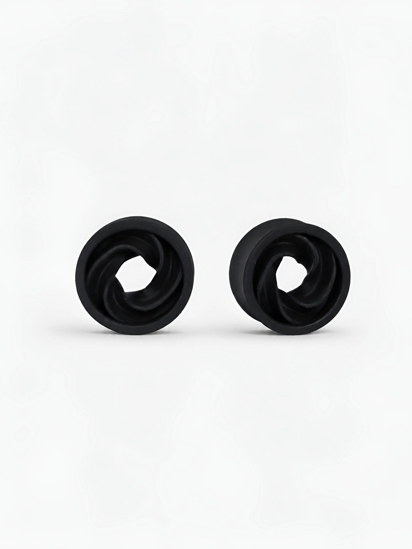 Pair of black Intertwine double flared ear tunnels on a white background